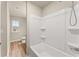 Bathroom with a tub shower combo, vinyl flooring, and window at 116 Cabin Way, Hampton, GA 30228