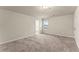 Spacious bedroom with plush carpet, neutral walls and a window at 116 Cabin Way, Hampton, GA 30228