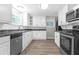 Well-lit kitchen features stainless steel appliances, white cabinets, and durable countertops at 2892 Cardinal Lake Dr, Duluth, GA 30096