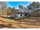 Exterior side view of home on a large lot with mature trees at 304 Old Yorkville Rd, Dallas, GA 30157