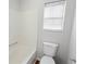 Bathroom featuring a white toilet, shower/tub combo, and natural light at 2413 Charleston Pointe Ct, Atlanta, GA 30316