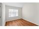 Bedroom with neutral paint, wood-look flooring, and a window that lets in plenty of natural light at 2413 Charleston Pointe Ct, Atlanta, GA 30316