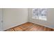 Bedroom with light walls and wood-look floors with natural light streaming in from the window at 2413 Charleston Pointe Ct, Atlanta, GA 30316