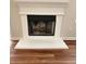Close-up of a traditional white fireplace with a black mesh screen, perfect for cozy evenings at 2413 Charleston Pointe Ct, Atlanta, GA 30316