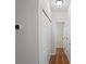 Hallway with wood floors, a thermostat, and white doors at 2413 Charleston Pointe Ct, Atlanta, GA 30316