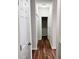 Hallway with wood floors, a light fixture, and white doors at 2413 Charleston Pointe Ct, Atlanta, GA 30316