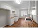 Bright kitchen with butcher block counters, white cabinets, stainless steel sink, and wood flooring at 2413 Charleston Pointe Ct, Atlanta, GA 30316