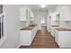 Kitchen with white cabinets, butcher block countertops, and wood-look flooring at 2413 Charleston Pointe Ct, Atlanta, GA 30316