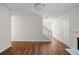 Open-concept living room with hardwood floors and neutral paint leading to fireplace and stairs at 2413 Charleston Pointe Ct, Atlanta, GA 30316