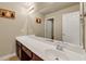 Bathroom featuring a long vanity with a white countertop and a large mirror at 2468 Cannon Farm Ln, Duluth, GA 30097