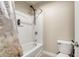 Standard bathroom with a shower-tub combo, toilet, and neutral decor at 2468 Cannon Farm Ln, Duluth, GA 30097