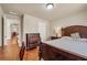 Bedroom featuring a wooden bed frame, bedside table, and a spacious dresser at 2468 Cannon Farm Ln, Duluth, GA 30097