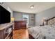 Well-lit bedroom with a plush bed, dresser, and warm, inviting decor at 2468 Cannon Farm Ln, Duluth, GA 30097