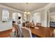 Spacious dining room boasting archways, chandelier, and ample seating at 2468 Cannon Farm Ln, Duluth, GA 30097