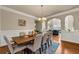 Elegant dining room with hardwood floors, chandelier, and wainscoting at 2468 Cannon Farm Ln, Duluth, GA 30097