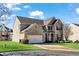 Brick two-story home featuring attached two-car garage and well-maintained lawn at 2468 Cannon Farm Ln, Duluth, GA 30097