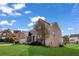 Exterior shot of two-story brick home with manicured lawn and blue sky at 2468 Cannon Farm Ln, Duluth, GA 30097