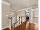 Upstairs hallway with hardwood floors, white railings and multiple windows with natural light at 2468 Cannon Farm Ln, Duluth, GA 30097