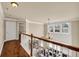 Second-story hallway with hardwood floors overlooking the main living area of the home at 2468 Cannon Farm Ln, Duluth, GA 30097