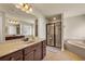 Beautiful bathroom with a soaking tub, separate shower, a large mirror, and dual vanity sinks at 2468 Cannon Farm Ln, Duluth, GA 30097