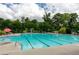Community swimming pool with clear blue water, lounge chairs, and lush surrounding greenery at 2468 Cannon Farm Ln, Duluth, GA 30097