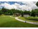 Scenic view of a gazebo near community tennis courts, surrounded by well-maintained lawns at 2468 Cannon Farm Ln, Duluth, GA 30097