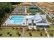 Overhead view of a community clubhouse, swimming pool, and tennis court showcasing community amenities at 5360 Memento Trce, Cumming, GA 30040