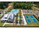 Community clubhouse aerial view with a swimming pool, tennis court, and community parking at 5360 Memento Trce, Cumming, GA 30040