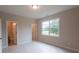 Bedroom featuring ample natural light from the large window, and access to a bathroom at 5360 Memento Trace, Cumming, GA 30040