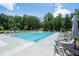 Inviting community pool surrounded by comfortable lounge chairs and lush greenery at 5360 Memento Trce, Cumming, GA 30040