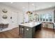 Spacious kitchen featuring a large marble island and wood-look flooring at 5360 Memento Trce, Cumming, GA 30040