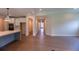 An open-concept living room showcases hardwood floors and access to the kitchen and a grand hallway at 5360 Memento Trce, Cumming, GA 30040