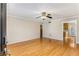 Sun-drenched living room with gleaming hardwood floors, neutral paint, crown moulding, and an elegant ceiling fan at 1101 Collier Nw Rd # R3, Atlanta, GA 30318