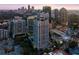 Breathtaking aerial view of a luxurious high-rise nestled in a vibrant cityscape at twilight at 199 14Th Ne St # 2407, Atlanta, GA 30309