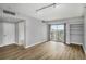 Bright and airy living room with hardwood floors and balcony access at 199 14Th Ne St # 2407, Atlanta, GA 30309