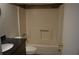 Bathroom features a bathtub-shower combo, toilet, and granite countertop vanity at 2100 Driftwood Cir, Cumming, GA 30041