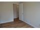 Bedroom with wood-look flooring and a white door with gold hardware at 2100 Driftwood Cir, Cumming, GA 30041