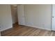 Bedroom with wood-look flooring and a white door with gold hardware at 2100 Driftwood Cir, Cumming, GA 30041