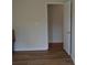 Bedroom with wood-look flooring and a white door with gold hardware at 2100 Driftwood Cir, Cumming, GA 30041