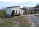View of an updated home with dual decks, landscaping, and a driveway in a rural neighborhood at 2100 Driftwood Cir, Cumming, GA 30041