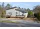 Beautiful home featuring a spacious deck and nestled among mature trees in a tranquil setting at 2100 Driftwood Cir, Cumming, GA 30041