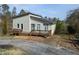 Exterior angle of a cozy home with new gray roof, dual decks, basketball hoop, and modern siding at 2100 Driftwood Cir, Cumming, GA 30041