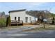 View of an updated home with dual decks, landscaping, mailbox, and a driveway in a rural neighborhood at 2100 Driftwood Cir, Cumming, GA 30041