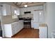 Well-equipped kitchen with bright white cabinets, stainless steel appliances, and ample countertop space at 2100 Driftwood Cir, Cumming, GA 30041