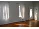 Bright living room with gleaming hardwood floors, freshly painted walls, and updated lighting fixtures at 2100 Driftwood Cir, Cumming, GA 30041