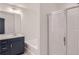 Bathroom featuring a vanity with sink, a large mirror, and a shower with glass doors at 5036 Longview Walk, Decatur, GA 30035