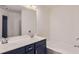 Spacious bathroom with double sinks, dark cabinets, a large mirror, and a soaking tub at 5036 Longview Walk, Decatur, GA 30035