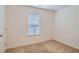 Empty bedroom with neutral carpet, white walls, and a window at 5036 Longview Walk, Decatur, GA 30035