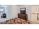 The bedroom features a dresser with a TV and a comfortable bed with patterned bedding at 5036 Longview Walk, Decatur, GA 30035