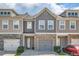 Charming townhome with stone accents, gray siding, and a two-car garage at 5036 Longview Walk, Decatur, GA 30035